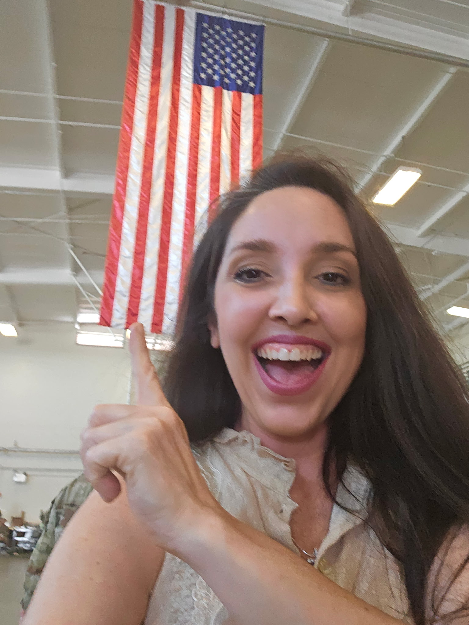 Roz Price at community event with American flag